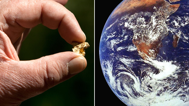 A man holding a nugget of gold and the planet earth